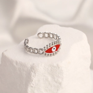 Detailed close-up of a silver chain ring with a red devil eye on a stone base