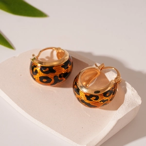 Detail of vintage leopard print hoop earrings with gold plating and enamel finish