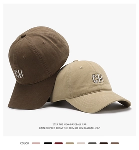 Detail of embroidered CH letters on brown and khaki baseball caps with curved brims