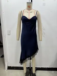Detail of navy satin dress showing the V-neck and black floral lace on the irregular hem