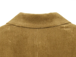 Detailed close-up of corduroy blazer collar showing texture and khaki fabric stitching