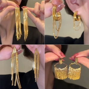 Set of four stylish gold tassel earrings with long chains and fringe in metallic finish