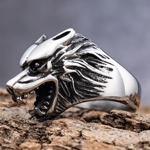 Detailed close-up of a silver wolf head ring showing intricate carved metal texture