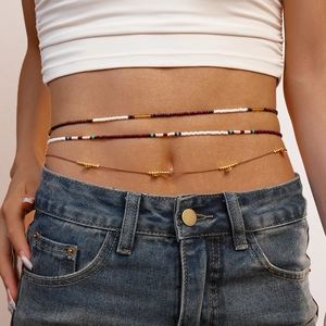 Close-up of a 3-piece bohemian waist chain set with colorful glass beads and gold metal accents