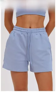 Detail view of grey blue sports shorts featuring elastic drawstring waist and side pockets