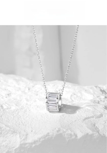 Macro shot of S925 silver necklace with baguette-cut zircon cylinder pendant