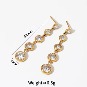 Detail view of 48mm long stainless steel earrings with gold finish and zircon tassels
