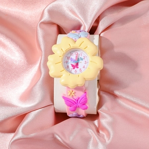 Detail of pink silicone watch band with 3D butterfly decor and floral case