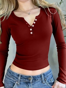 Detail view of burgundy ribbed long sleeve top with button half-placket and slim fit design