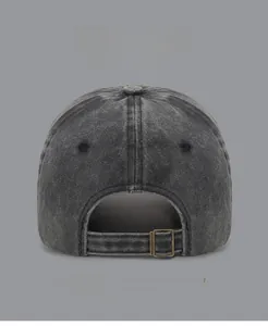Detail of adjustable metal buckle and washed denim texture on vintage baseball cap