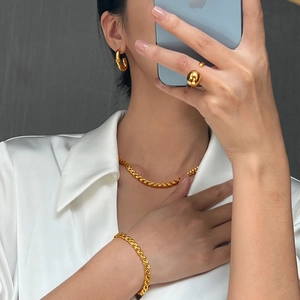 Minimalist gold geometric chain jewelry set with necklace and earrings on model