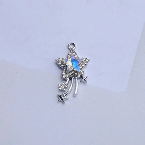 Macro detail of silver star pendant with rhinestones and iridescent center