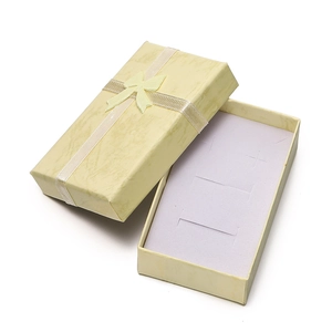Detail of cream marble pattern jewelry gift box with ribbon bow and purple sponge insert