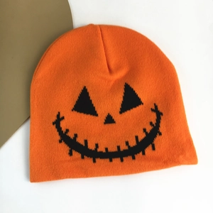 Orange Halloween knit beanie featuring a black pumpkin jack-o-lantern face print