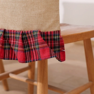 Detail of Christmas chair cover showing linen texture and red black plaid ruffle edge