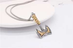 Detailed view of Viking double axe pendant with golden eagle relief and steel chain