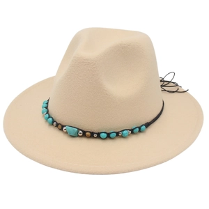 Detailed shot of beige wide-brim fedora hat with bohemian turquoise bead and metal band