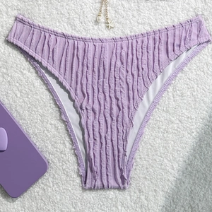 Detailed view of lavender textured bikini bottom with pearl starfish pendant decoration