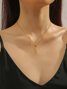 Close-up of elegant 3D rose pendant necklace in gold finish worn by a model