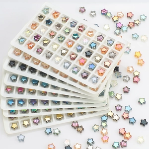 Close-up of colorful 8mm star-shaped glass beads with iridescent finish in white trays