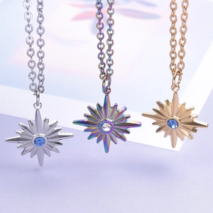 Star pendant necklaces in gold, silver, and iridescent finishes with center crystal stones
