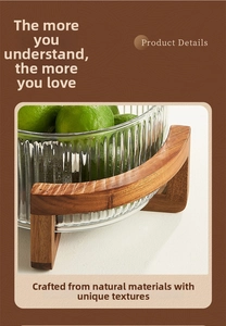 Close-up of vertical striped glass fruit bowl with a natural wooden pedestal base