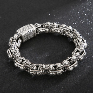 Detailed view of silver skull bracelet with vintage punk chain link design in steel