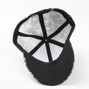 Detail view of pink floral baseball cap showing inner black lining and premium stitching
