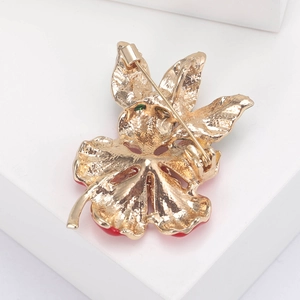 Exquisite golden enamel peach blossom brooch with red petals and green gem accents