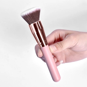 Flat top foundation brush with pink handle and rose gold ferrule for makeup