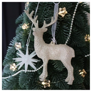 Sparkling champagne gold reindeer and white star ornaments hanging on a Christmas tree