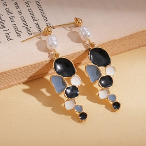 Detail of vintage irregular geometric drop earrings with colorful enamel and white pearls