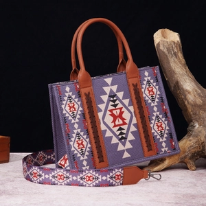 Detail of bohemian purple bag with ethnic geometric pattern and woven leather handle