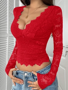 Close-up of red lace long sleeve top featuring a deep V-neck and scalloped edges