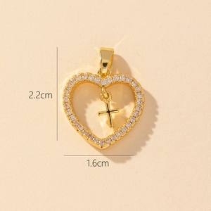 Detailed close-up of a gold heart pendant with zircon frame and cross, size 2.2x1.6cm