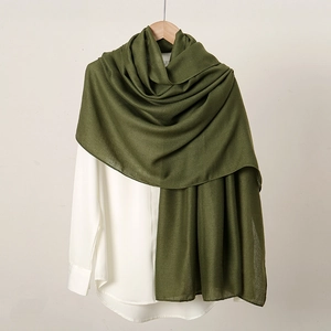 Army green linen-feel long scarf for women on wooden hanger with white shirt