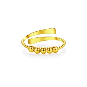 Macro shot of gold anti-anxiety ring with five movable beads on an adjustable band