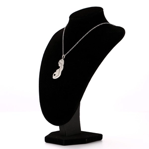 Detailed view of silver maternity pendant with heart silhouette on a black mannequin display