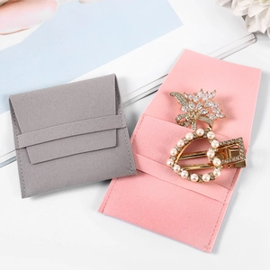 Pink and grey microfiber jewelry pouches with elegant crystal flower and pearl heart hair clips