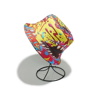 Close-up of vibrant graffiti monster print on yellow canvas sun hat with sharp details