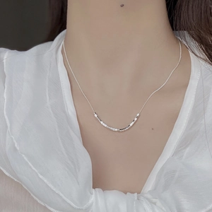 Minimalist 925 sterling silver geometric cube necklace worn by model on white background