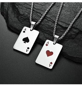Detail of spade and heart poker pendants with brushed steel finish on bead chains