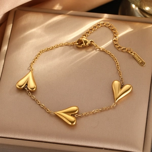 Elegant gold-plated stainless steel bracelet with three heart pendants and lobster clasp