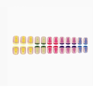 Short square Easter press-on nails featuring colorful bunny designs on translucent base