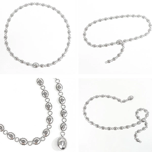 Detail of vintage silver metal waist chain with ornate flower engraved oval links