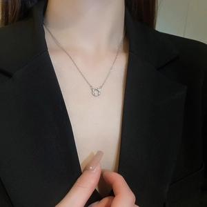 Chic silver stainless steel circle necklace with zircon stones worn by a model