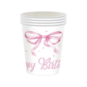 Close-up of disposable birthday paper cups with pink watercolor bow and Happy Birthday text