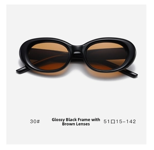 Detail view of oval cat-eye sunglasses with glossy black frame and translucent tea lenses