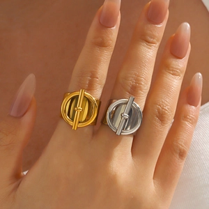 Fashionable gold and silver stainless steel OT toggle rings worn by a model