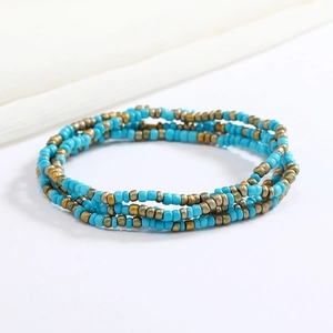 Detail of handmade sky blue and bronze beaded multi-layer body chain waist beads